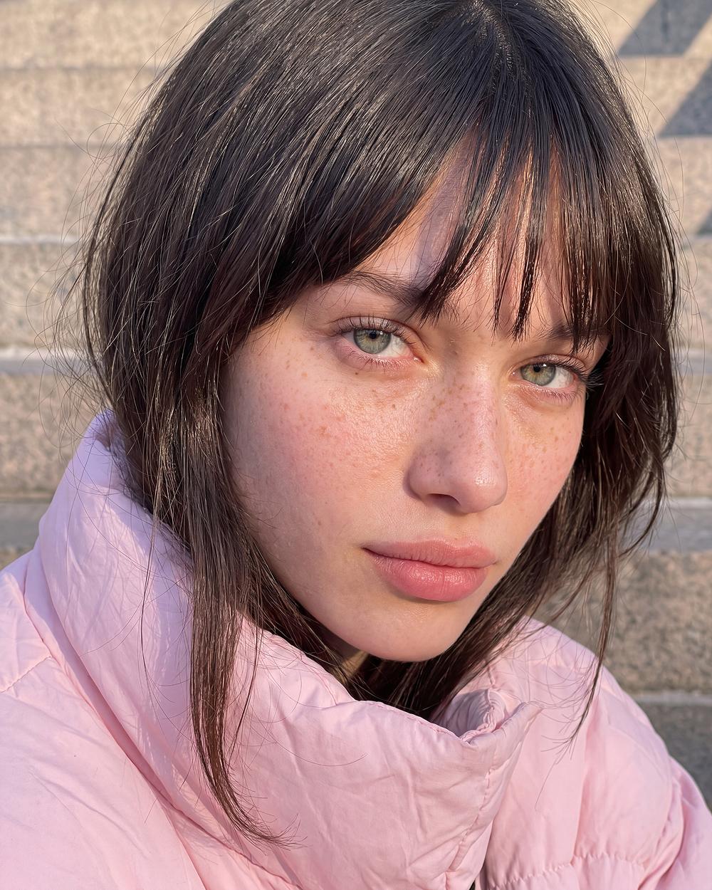 Bangs, pink jacket, stone steps