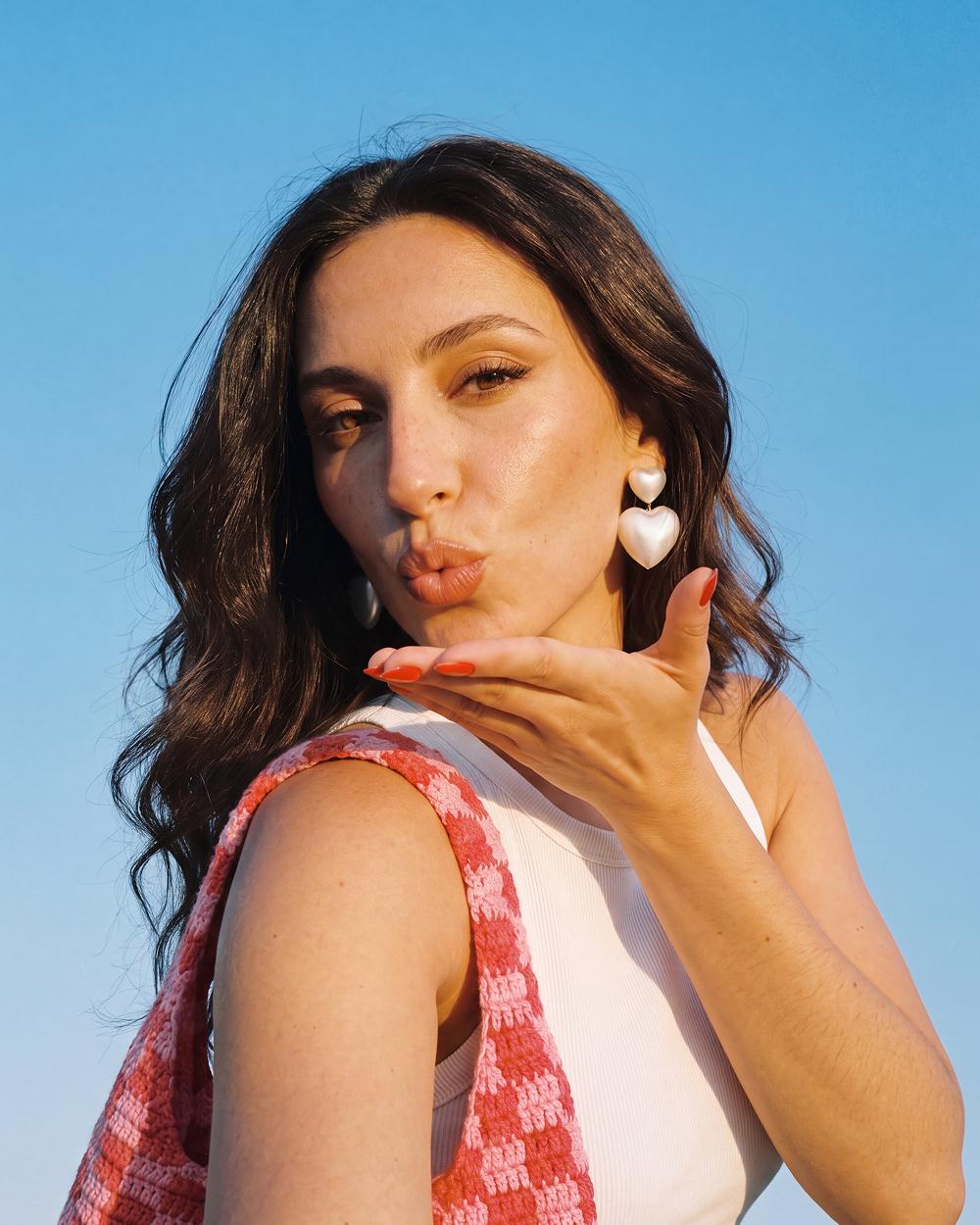 Blowing a kiss, heart earrings