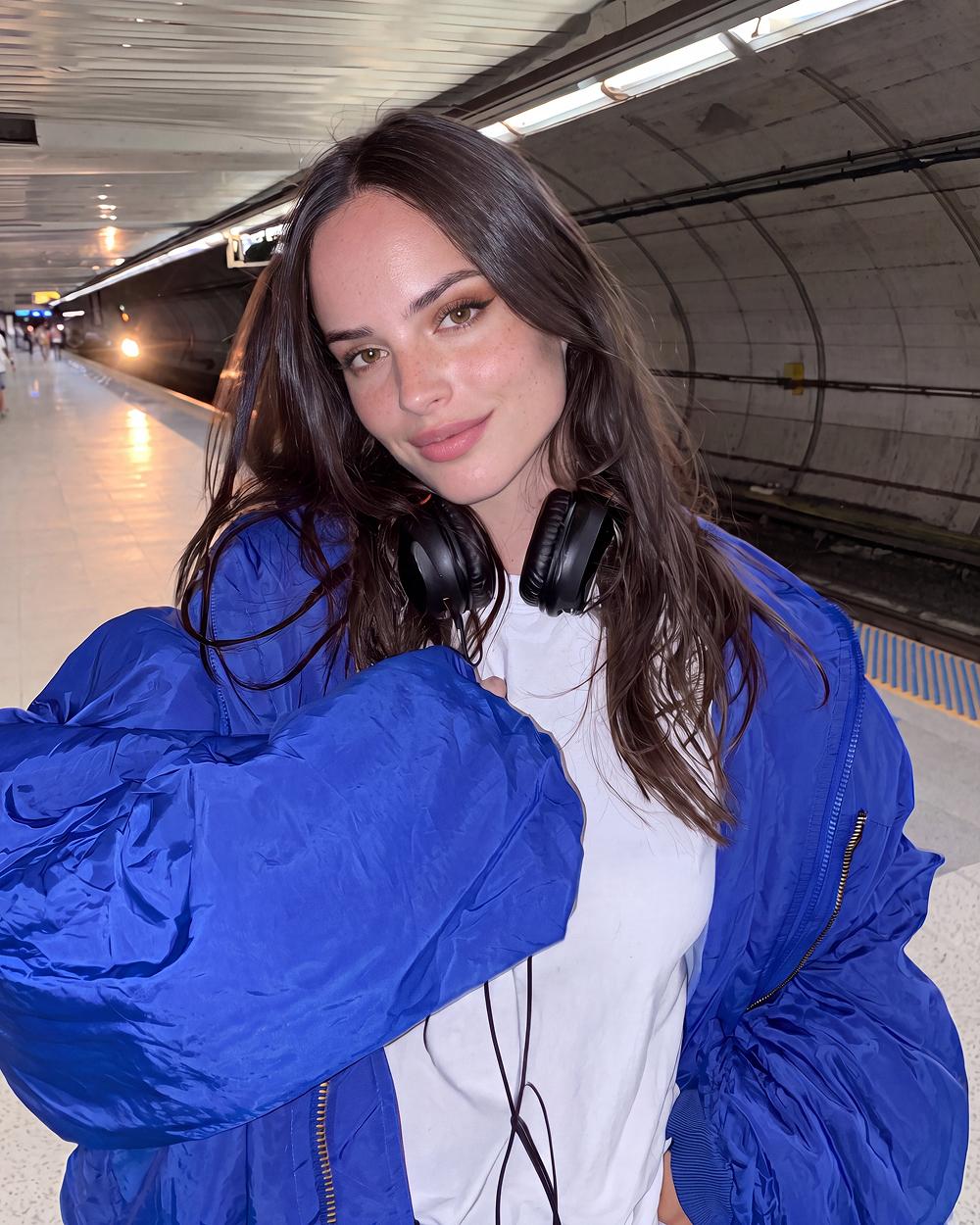 Blue jacket, subway, headphones