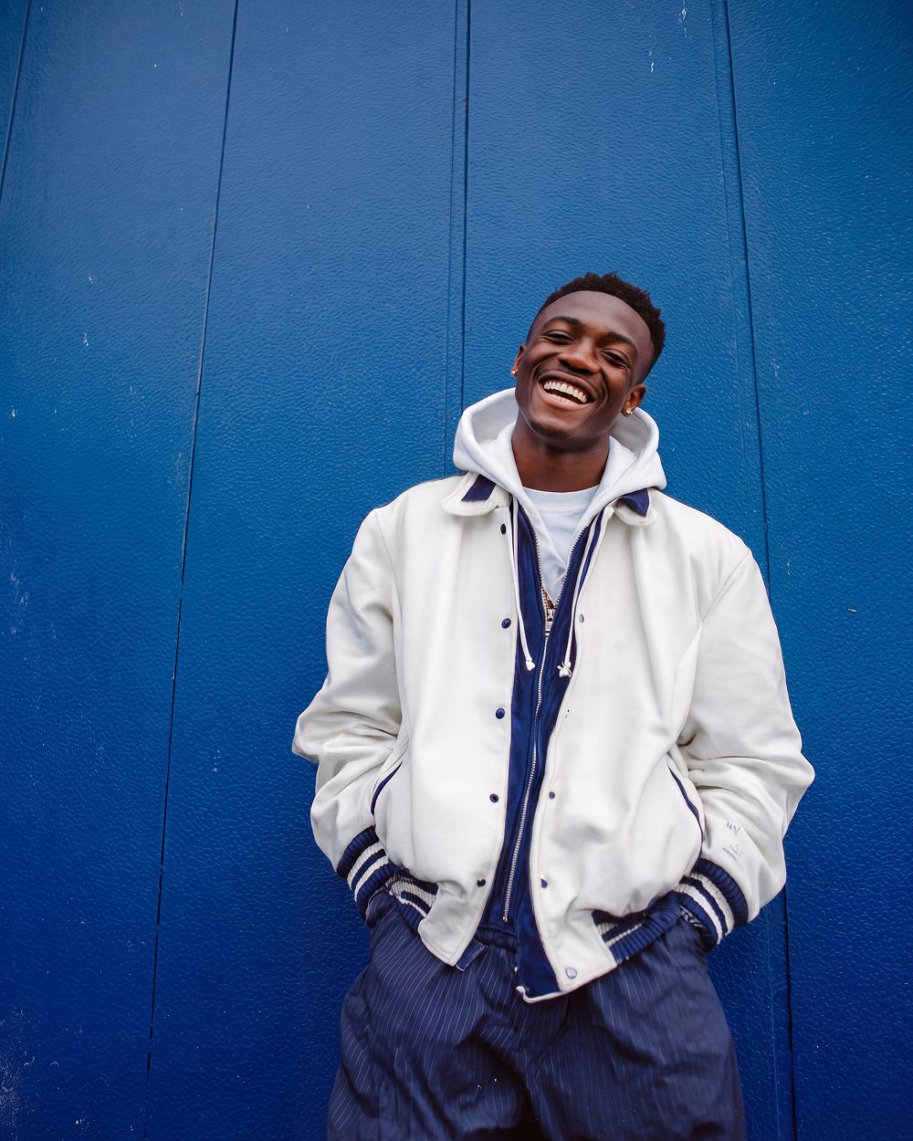 Varsity jacket, blue wall
