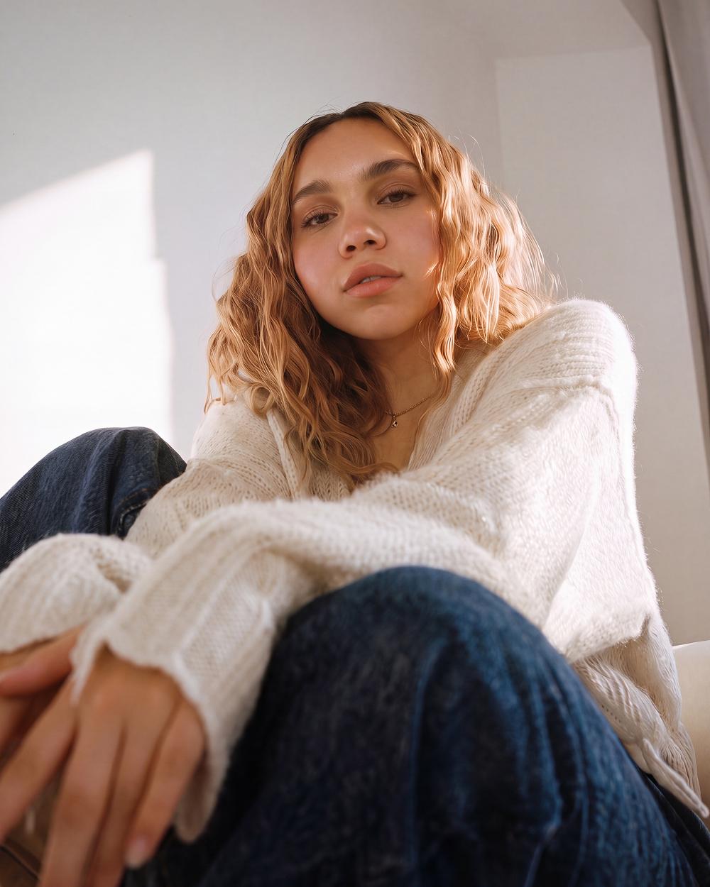 White sweater, curly hair
